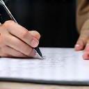 Trainer writing customised plan on clipboard