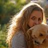 Woman hugging golden retriever in Bristol garden